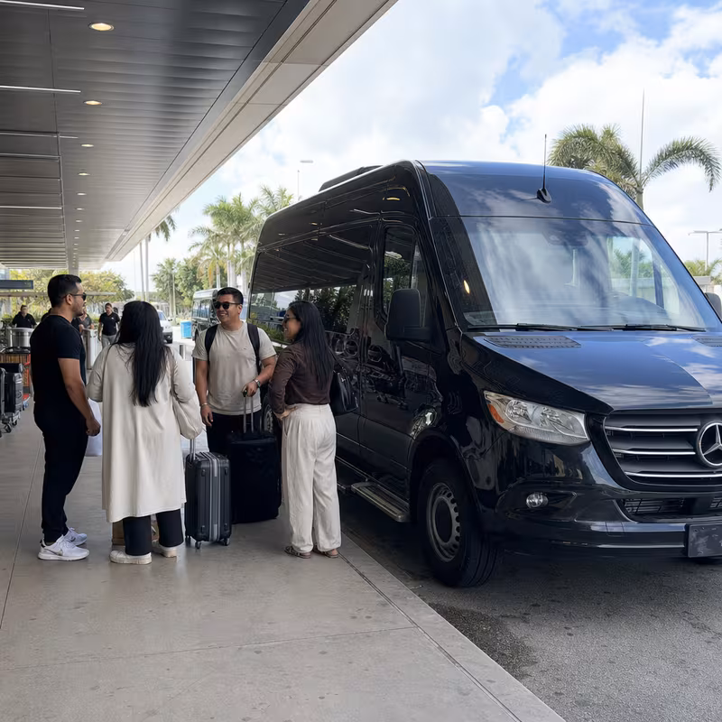 Group boarding a white charter bus for Airport Transportation transportation in Davie