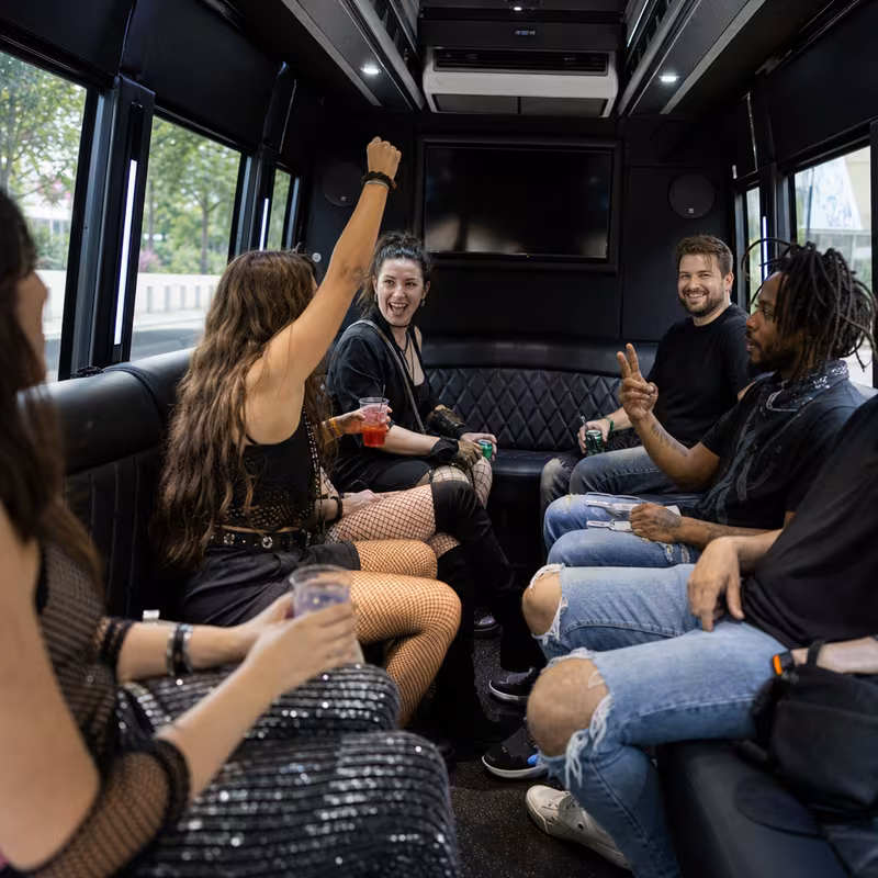 Group boarding a white charter bus for Concert Transportation transportation in Davie