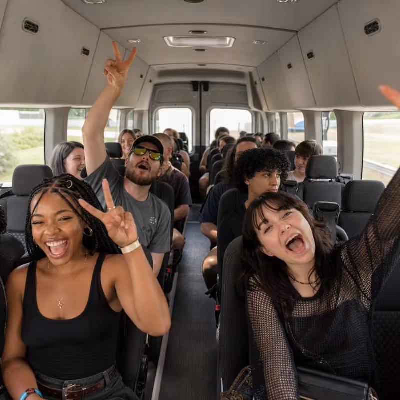Party bus interior with wraparound leather seating and LED lighting in Davie