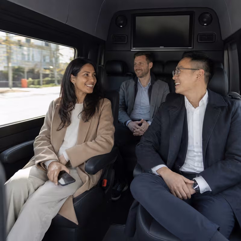 Group boarding a white charter bus for Corporate Transportation transportation in Davie