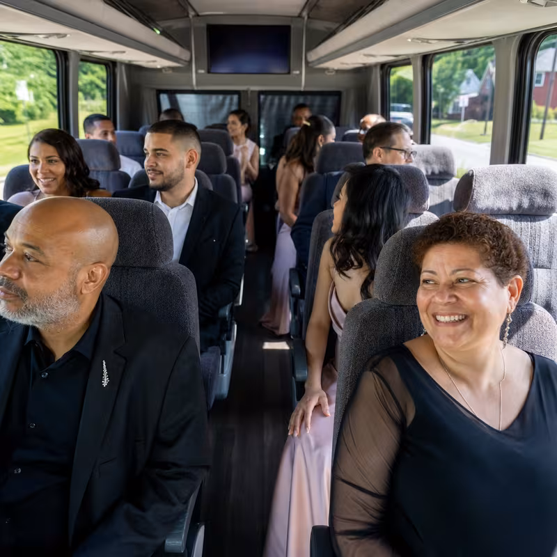 Group boarding a white charter bus for Private Event Transportation transportation in Davie