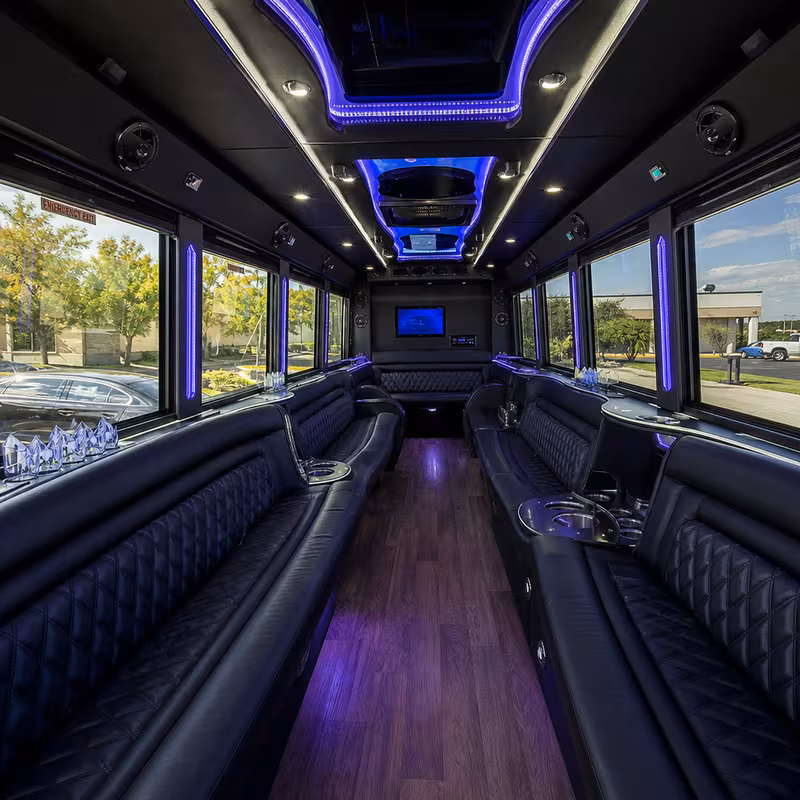 Party bus interior with wraparound leather seating and LED lighting in Davie