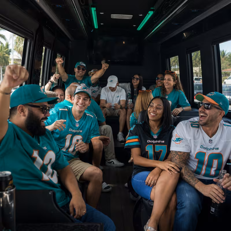 Group boarding a white charter bus for Sporting Event Transportation transportation in Davie