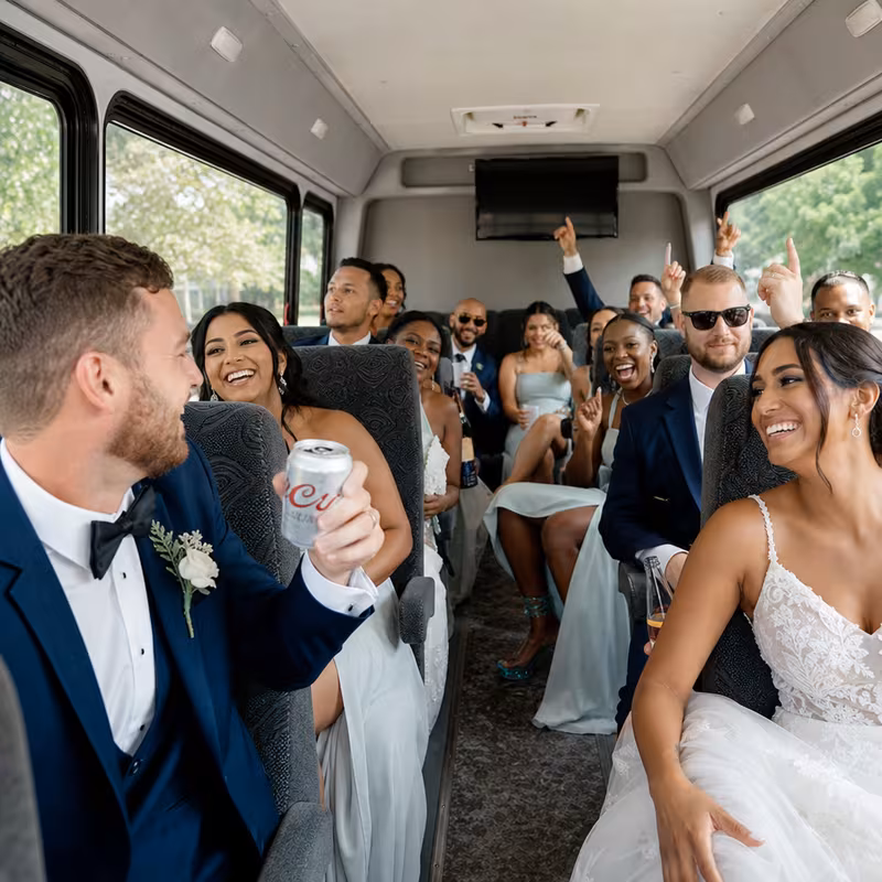Group boarding a white charter bus for Wedding Transportation transportation in Davie