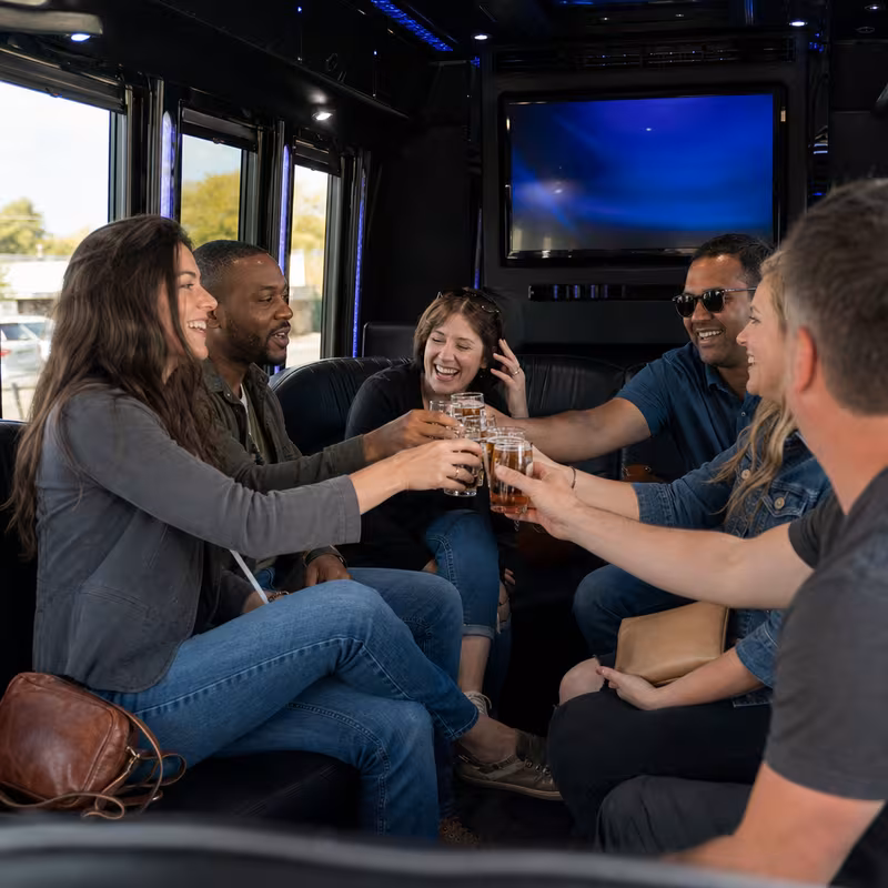 Group boarding a white charter bus for Winery & Brewery Tour Transportation transportation in Davie