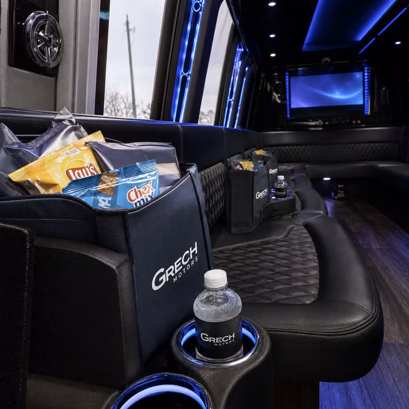 Party bus interior with wraparound leather seating and LED lighting in Davie